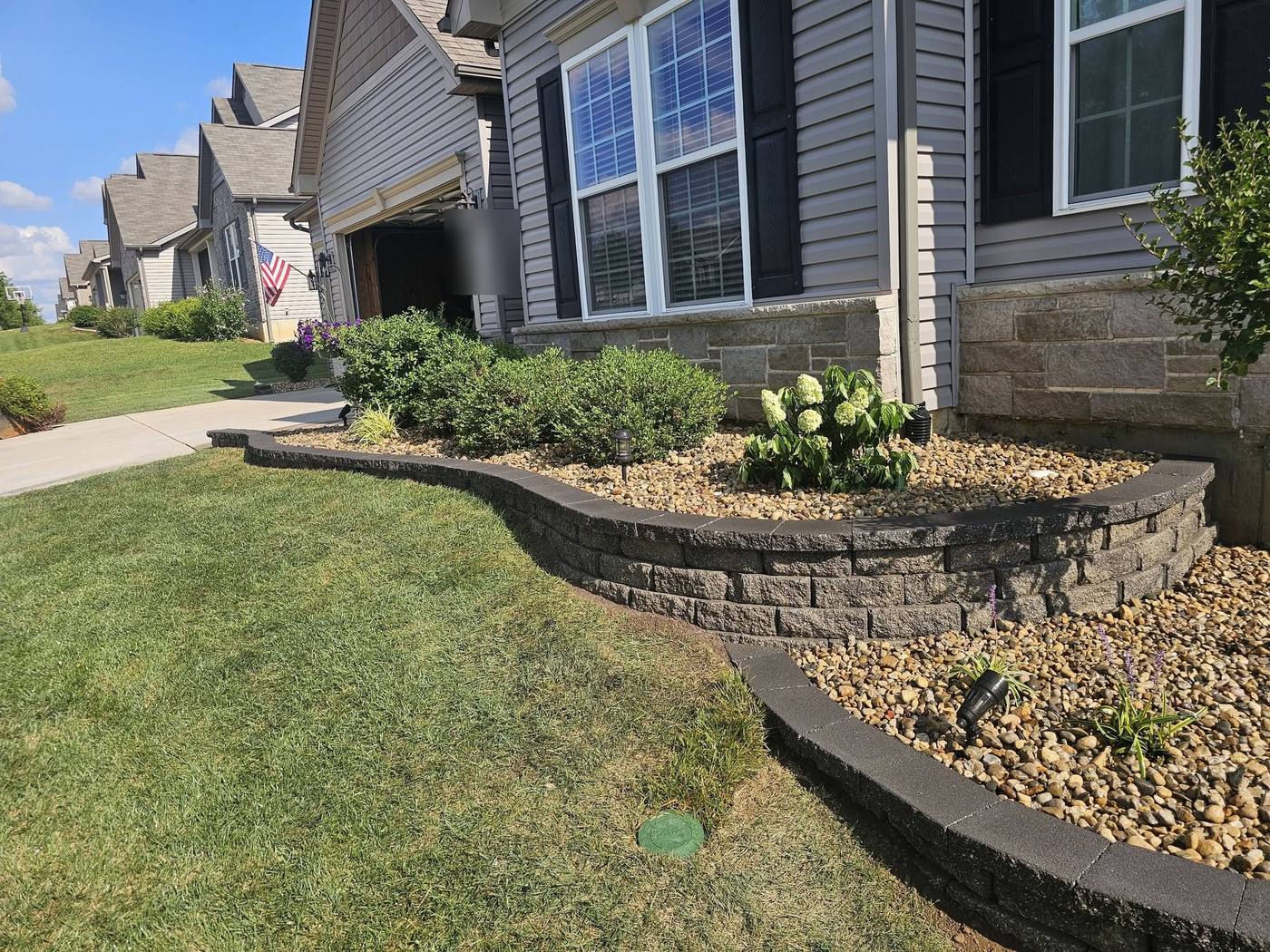Curving block wall along the front of the house
