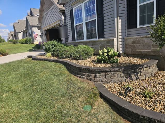 Curving block wall along the front of the house